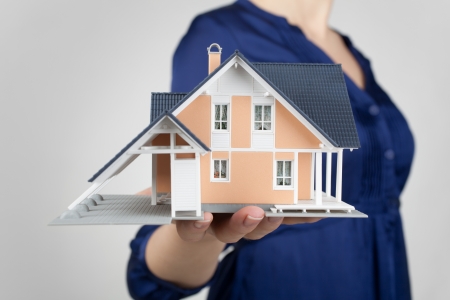 Real estate agent offer house represented by model  の写真素材