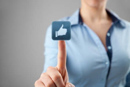 Social media concept  Young woman click on the like button  の写真素材