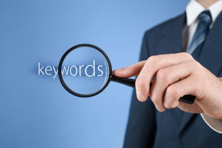Keywords analysis, look for, search for and seek concept. Man with magnifying glass and text keywords.
の写真素材