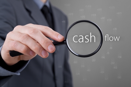 Focus on cash flow and audit of accounts concept. Businessman (auditor) analyze cash flow. Positive numbers fly up, negative numbers fly down.
の写真素材