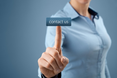Contact us, customer care or helpline concept. Woman click on virtual button with contact us text.の写真素材