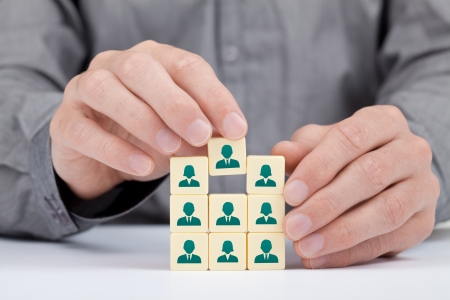 Human resources and social networking concept - recruiter complete team by one person  employee  represented by icon  の写真素材