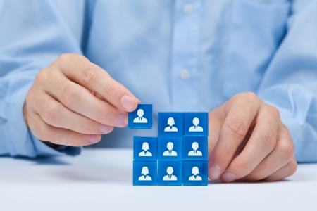 Human resources, social networking, assessment center concept, personal audit or CRM concept - recruiter complete team by one person  Employees are represented by blue glass cubes with icons の写真素材