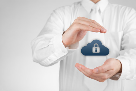 Cloud storage security concept. Security and safety of cloud computing data storage. Protecting gesture of safety data management specialist and cloud icon with padlock.の写真素材