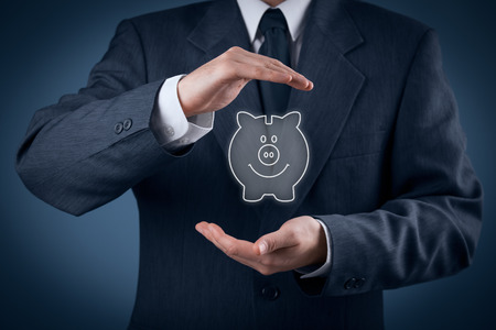 Protect your money (financial savings) and financial care (services) concept. Financial advisor (financial consultant) with protective gesture and piggy bank.の写真素材