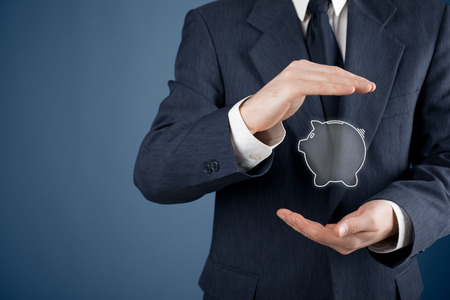 Protect your money (financial savings) and financial care (services) concept. Financial advisor (financial consultant) with protective gesture and piggy bank.の写真素材