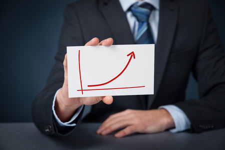 Positive growth, success and progress concept. Businessman with growing graph drawn on card.の写真素材