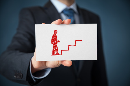 Personal development (personal growth), success, progress, potential and career concepts. Male coach (human resources officer, supervisor) with card and drawn stairs to help employee with his career growth.の写真素材