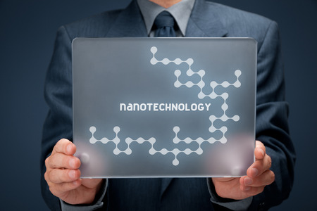 Nanotechnology concept. Man holding futuristic tablet pc with nanotechnology design.の写真素材