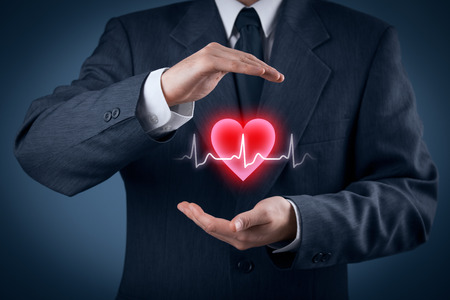 Protect health (healthcare) and heart problems prevention (cardiology) concept. Cardiologist with protective gesture and symbol of heart and ECG heartbeat.の写真素材