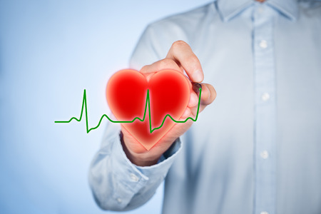 Healthcare and heart problems prevention (cardiology) concept. Cardiologist draw symbol of heart and ECG heartbeat.の写真素材