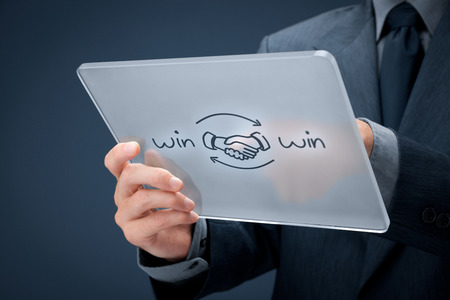 Win-win partnership strategy concept. Businessman click (select) on futuristic tablet computer win-winstrategy.の写真素材
