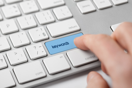 Find keywords concept. Marketing specialist looking for keywords (concept with keyboard).の写真素材