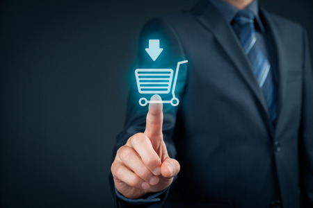 Businessman click on virtual e-shop button with shopping cart. E-commerce and B2C, man buy or download online concept.の写真素材