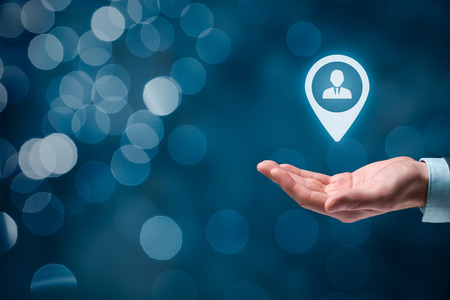 Target customer and human resources (HR) concept, beautiful bokeh in background. Man hold target customer, employee (or another business person) in hand.の写真素材