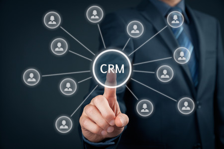 Customer relationship management (CRM) concept. Businessman click on button with text CRM, linked with customers.の写真素材