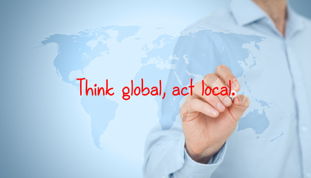 Think global, act local. Globalization business rule. Businessman draw this rule on virtual board.