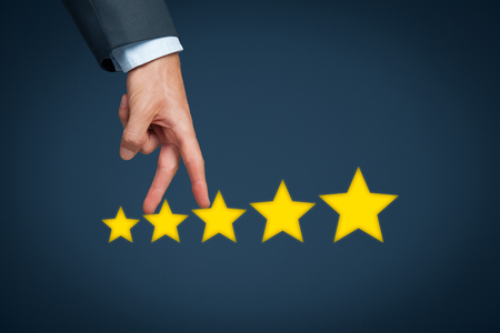 Increase rating, evaluation and classification concept. Businessman represented by hand rise on increasing five stars.の写真素材