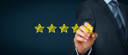 Increase rating, evaluation and classification concept. Businessman draw five yellow star to increase rating of his company. Wide banner composition.の写真素材