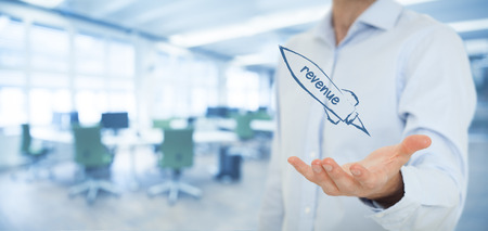 Increase revenue concept. Businessman help to speedily increase revenue. Spaceship representing dynamic growth. Wide banner composition with office in background.の写真素材