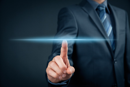 Businessman click on virtual touchscreen. Futuristic business and IT presentation background.の写真素材