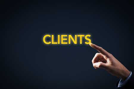 Be in touch (have contact) with clients concept. Key account manager or marketing specialist has a magic touch to work with clients. Businessman touch on gold text clients.の写真素材