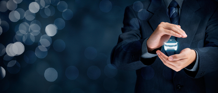 Car (automobile) insurance and collision damage waiver concepts. Businessman with protective gesture and icon of car. Wide banner composition with bokeh in background.の写真素材