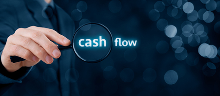 Focus on cash flow and audit of accounts concept. Businessman (auditor) analyze cash flow. Wide banner composition with bokeh in background.の写真素材