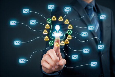 Protect e-mail against spam (junk mail) concept. Envelopes representing e-mails, icons representing  information about mail and end user with notebook.の写真素材