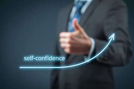 Self-confidence improvement concept. Businessman is satisfied with growing self-confidence.の写真素材