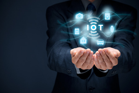 Internet of things (IoT) concept. Businessman offer IoT solution represented by symbol connected with icons of typical IoT  intelligent house, car, camera, watch, washing machine and cooker.の写真素材