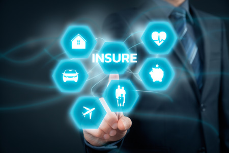 Insurance concept. Businessman (or insurance agent or client) click on insure button. Insurance icons: real estate insurance, car insurance, travel insurance, family and life insurance, financial insurance and health insurance.の写真素材