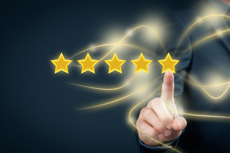 Review, increase rating or ranking, evaluation and classification concept. Businessman click on the fifth yellow star to increase rating of his company.の写真素材