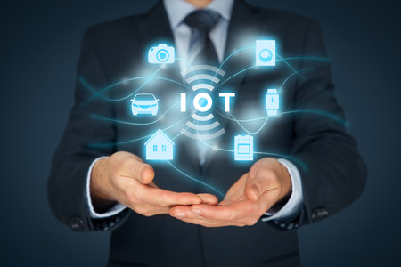 Internet of things (IoT) concept. Businessman offer IoT solution represented by symbol connected with icons of typical IoT  intelligent house, car, camera, watch, washing machine and cooker.の写真素材