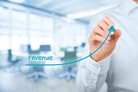 Increase revenue concept. Businessman plan revenue growth, office in background.の写真素材