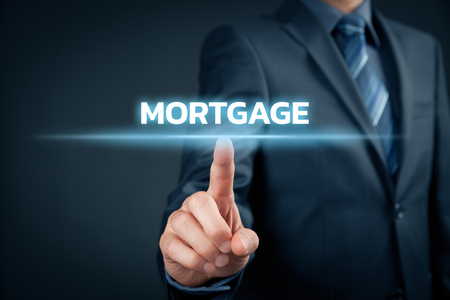Mortgage concept. Financial agent (client, businessman) click on text mortgage.の写真素材