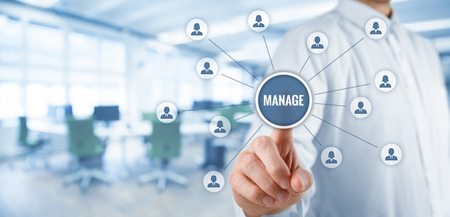 Manager click on button with text manage. Managerial business concept. Wide banner composition with office in background.の写真素材