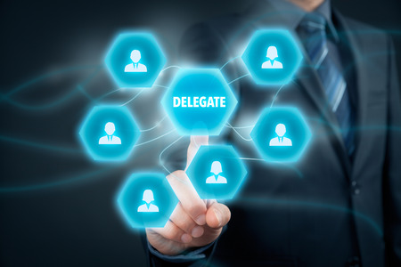 Manager delegate work on another person in team. Managerial concept with delegation.の写真素材