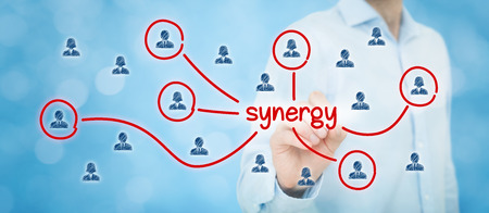Synergy opportunity concept. Manager (businessman) connect team members with text synergy, cooperating team connected with this text.の写真素材