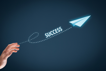 Accelerate success concept. Businessman throw a paper plane symbolizing growing (accelerating) success.の写真素材