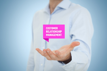 Customer relationship management (CRM) concept. Businessman hold virtual label with Customer Relationship Management text.の写真素材