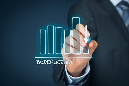 Bureaucracy reduction concept. Businessman draw graph with bureaucracy reduction.の写真素材
