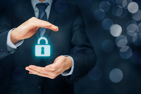 Security services and protection concept. Login, sign in concepts. Businessman offer padlock, symbol of security. Left composition with bokeh in background.の写真素材
