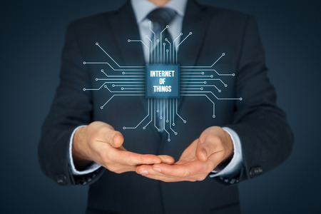Internet of things (IoT) concept. Businessman offer Internet of Things products and solutions. Abstract chip with text Internet of Things connected with abstract devices represented by points.の写真素材