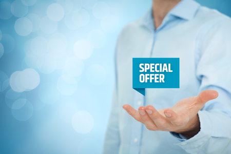 Special offer business model and marketing offer concept. Businessman hold virtual label with text special offer, bokeh on background.の写真素材