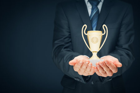 Business success, benchmarking and be number one on market concepts. Businessman hold cup representing success. Coach motivate to succeed.の写真素材