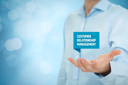Customer relationship management (CRM) concept. Businessman hold virtual label with Customer Relationship Management text.の写真素材