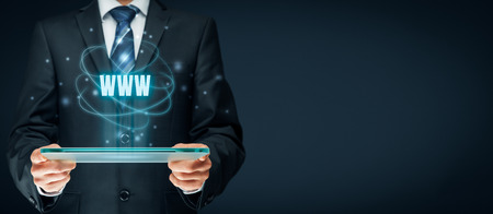 Internet websites and SEO concepts. Businessman hold futuristic tablet with head-up display and text www.の写真素材