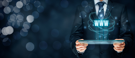 Internet websites and SEO concepts. Businessman hold futuristic tablet with head-up display and text www.の写真素材