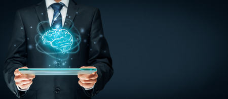 Artificial intelligence (AI), machine deep learning, data mining, expert system software, and another modern computer technologies concepts. Brain representing artificial intelligence and businessman holding futuristic tablet.の写真素材